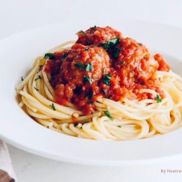 A rich and flavorful spaghetti sauce simmering in a pan with fresh garlic, onions, and herbs, ready to be transformed into a delicious new dish.