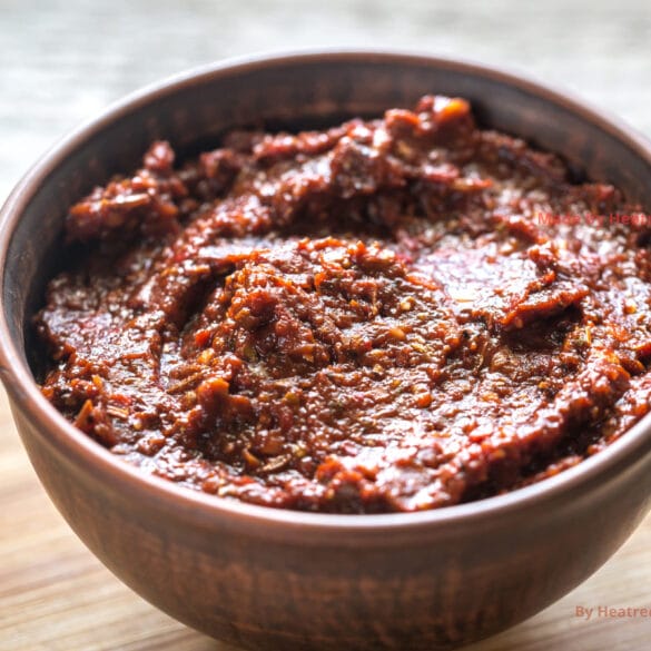 A rich and smoky homemade adobo sauce made with dried chilies, garlic, and chipotle peppers, simmering in a saucepan, ready to be used as a flavorful marinade or topping