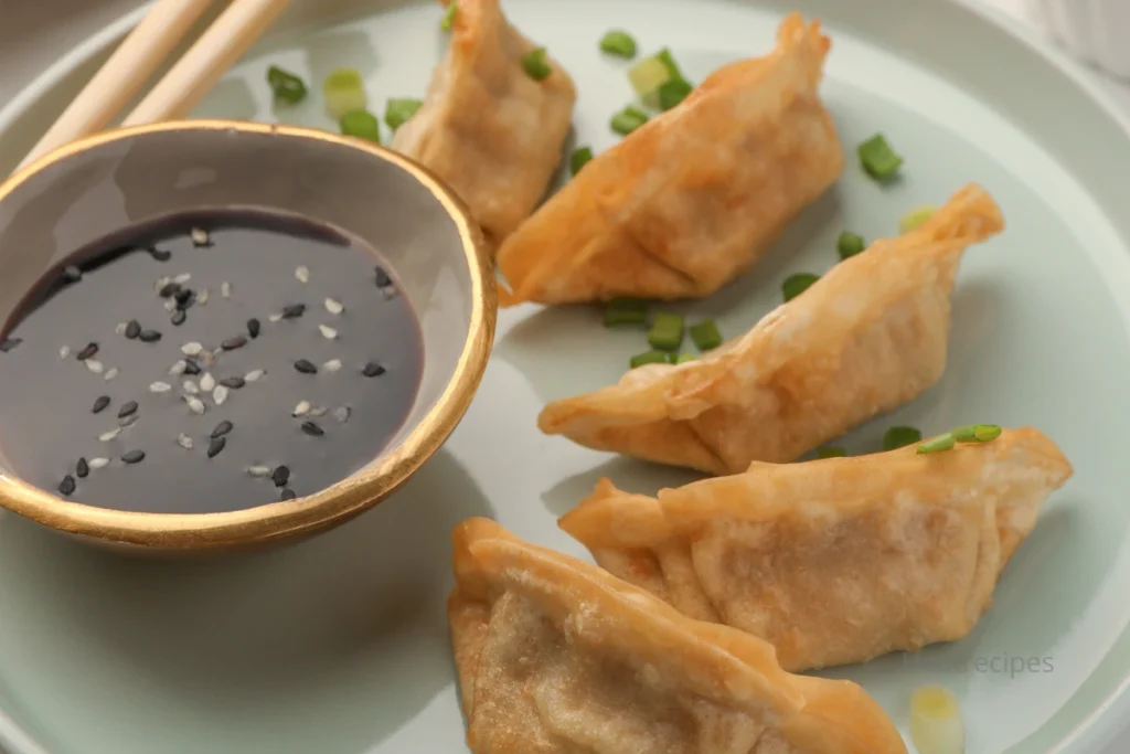 Making homemade gyoza sauce recipe with soy sauce, rice vinegar, and sesame oil