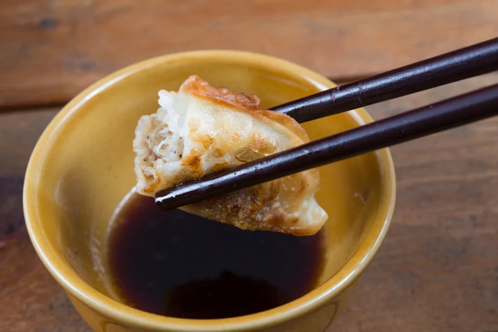 Homemade gyoza  sauce recipe in a small bowl with chili flakes