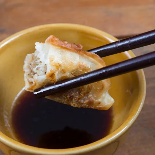 Homemade gyoza sauce recipe in a small bowl with chili flakes